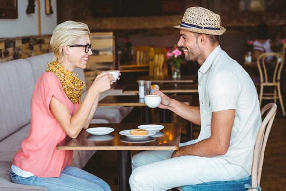 cute-couple-on-a-date-talking-over-a-cup-of-coffee-at-the-cafe