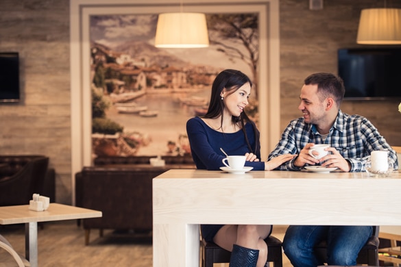 Young couple talking in coffee shop - How Can You Make An Aquarius Man Miss You