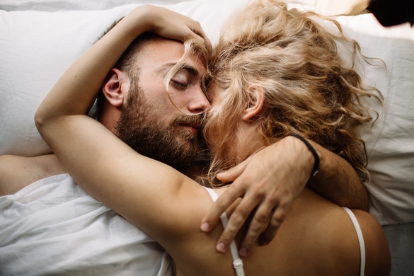 Couple in love lying in bed